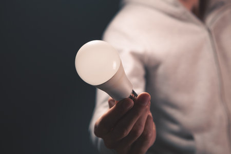 man holds a light bulb