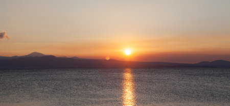 sunset on a lake in the mountains in the eveningの写真素材