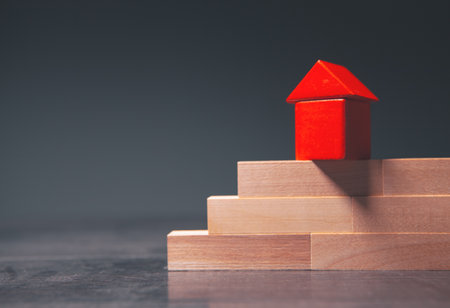 wooden blocks on a red house modelの写真素材
