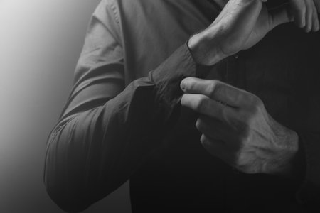 close - up of a man's hand in a black shirtの写真素材