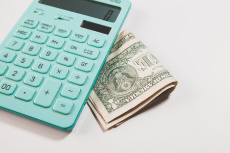 calculator and banknotes on the table.の写真素材