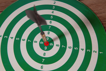 dart board and dart arrow in the business target