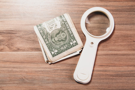 dollar banknote with magnifying glassの写真素材