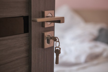 a closeup shot of an open white lock with key in bedroom