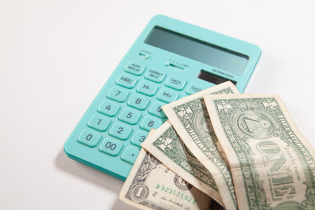 Calculator and dollars on a white background. Business concept.の写真素材