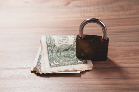 padlock on the table with dollar bills.の写真素材