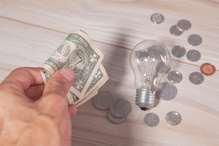 hand holding a light bulb on a white backgroundの写真素材