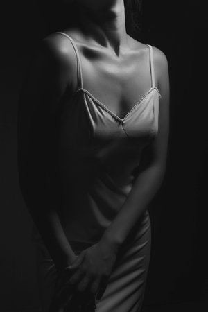 Beautiful slim body of woman in studio. Black and white photo.の写真素材