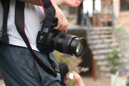 Photographer with a camera in his hands. Selective focus.