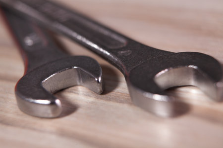 Two spanners on a wooden background. Close-up. Macro.