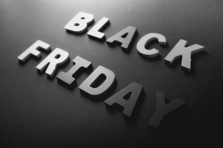 Black Friday inscription made of wooden letters on a black background. Black Friday concept.