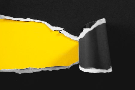Torn paper with space for your message on yellow and black backgroundの写真素材