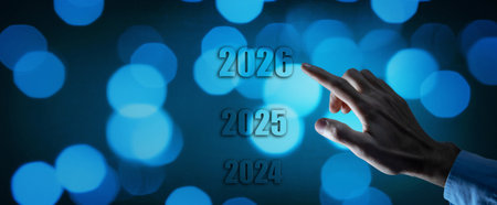 Businessman hand pointing at 2026 on virtual screen. New year conceptの写真素材