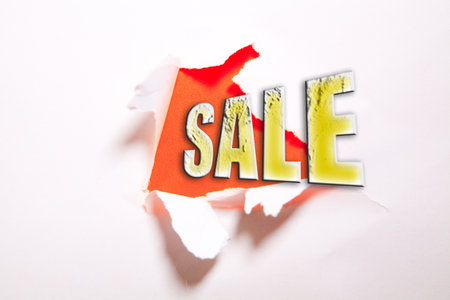 The word sale appearing behind torn paper with space for your text.