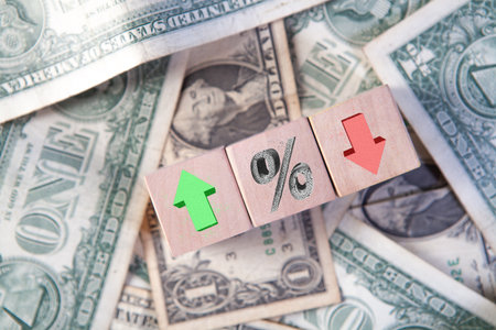 Discounts on wooden cubes with dollar banknotes as background.の写真素材