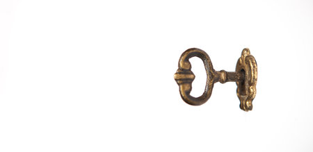 Old key isolated on a white background. Antique metal key.の写真素材