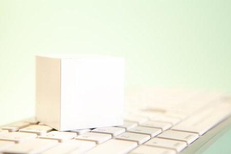 Blank white paper cube on computer keyboard, business and technology conceptの写真素材