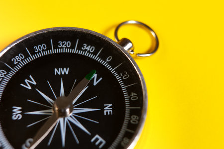 Compass on a yellow background. Close-up. Copy space.の写真素材