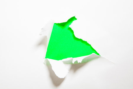 Torn paper with space for your message on a green background.の写真素材
