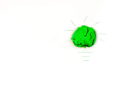 Green crumpled paper ball on white background. Isolated.の写真素材
