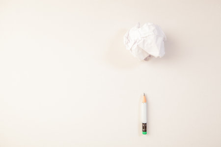 White crumpled paper ball and pencil on white background, business conceptの写真素材