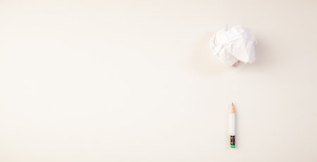 White crumpled paper and pencil on a white background with copy spaceの写真素材