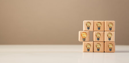 Wooden cubes with light bulbs on a gray background. Business concept