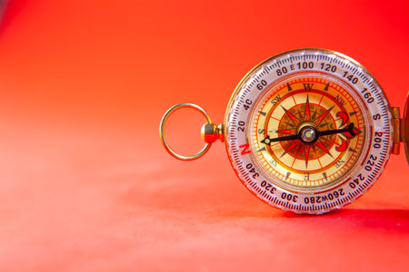 Compass on a red background. The concept of travel and navigation.の写真素材
