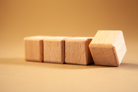 Wooden cubes on a yellow background.