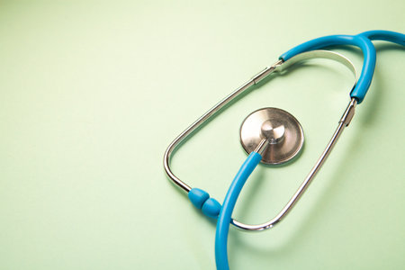 Stethoscope on a green background. Medical and health care concept.