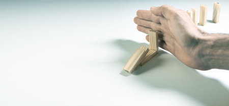 Man playing dominoes on white background. Concept of risk, chance and success.の写真素材