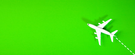 Airplane on green background with copy space. Travel and transport conceptの写真素材