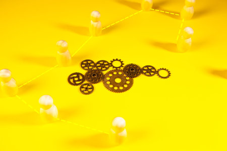 Teamwork concept. Teamwork concept. Gears and cogwheels on yellow backgroundの写真素材