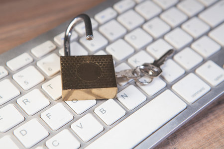 Padlock and key on a computer keyboard. Security and safety concept.