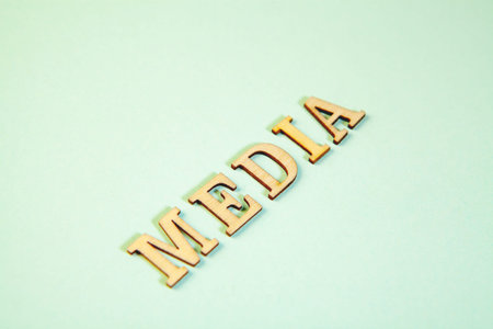 word media made of wooden letters on color backgroundの写真素材