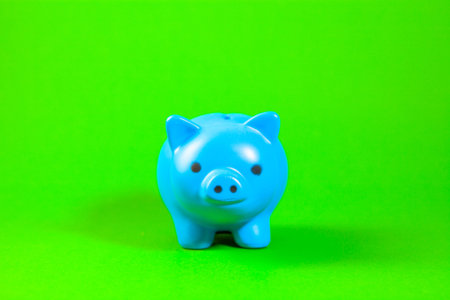 Blue piggy bank on a green background. Save money concept.