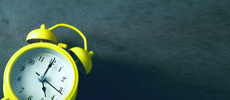 Yellow alarm clock on dark background. Time concept. 3D Rendering