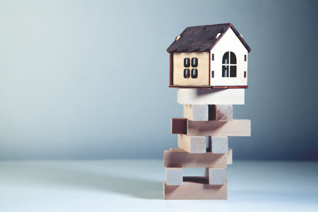 Wooden toy house on a white background. The concept of buying and selling real estate.