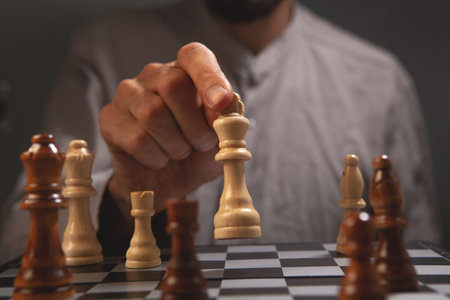 Close-up of man playing chess. Concept of business strategy.