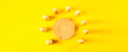 Flat lay composition with wooden podium on yellow background. Top view.