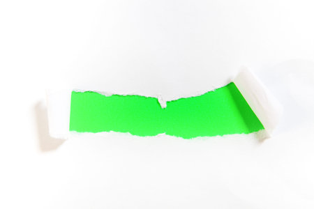 Torn paper with space for your message on a green background.の写真素材