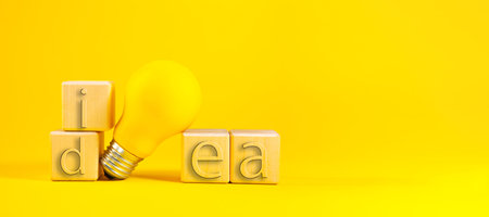 Light bulb with word idea and wooden blocks on a yellow background. 3d illustrationの写真素材