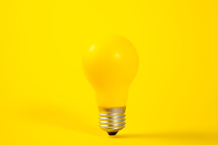 Yellow light bulb on a yellow background, concept of idea and innovation