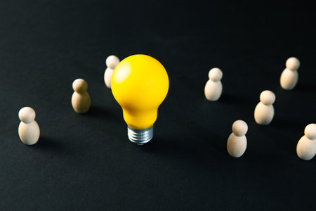 Yellow light bulb among the crowd of people. Business leadership concept.