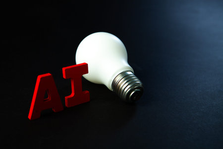 Light bulb on black background with red letters.