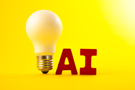 Light bulb on yellow background with word AI. Artificial intelligence concept.