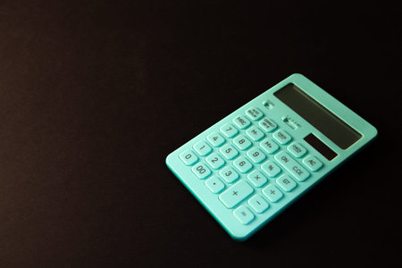 Calculator isolated on black background with copy space for text.
