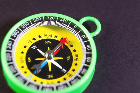 Yellow crumpled paper ball and yellow pencil on a green background.の写真素材