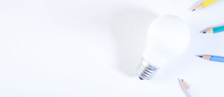 Light bulb and pencils on white background, creative idea concept.