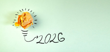 New Year 2026 concept with crumpled paper ball and lightbulb
